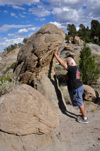 Lee Duquette trying to push a big rock down the cliff